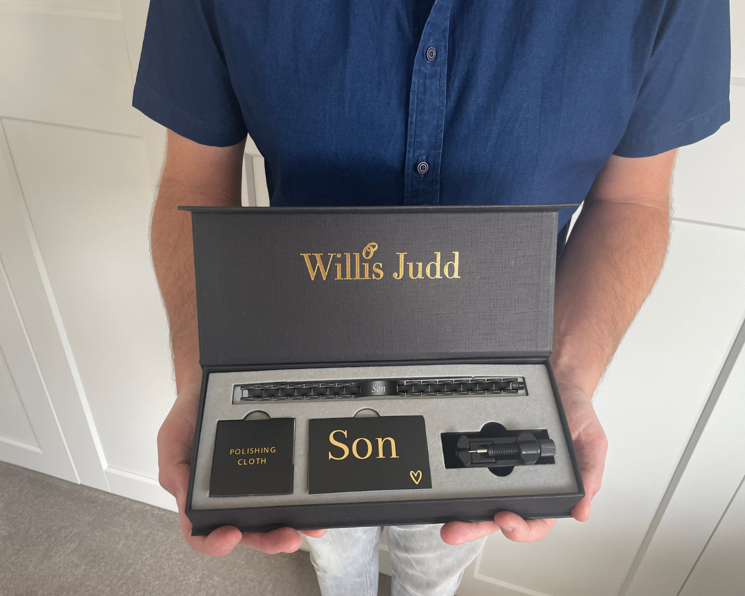 Man holding love you son etched bracelet in gift box
