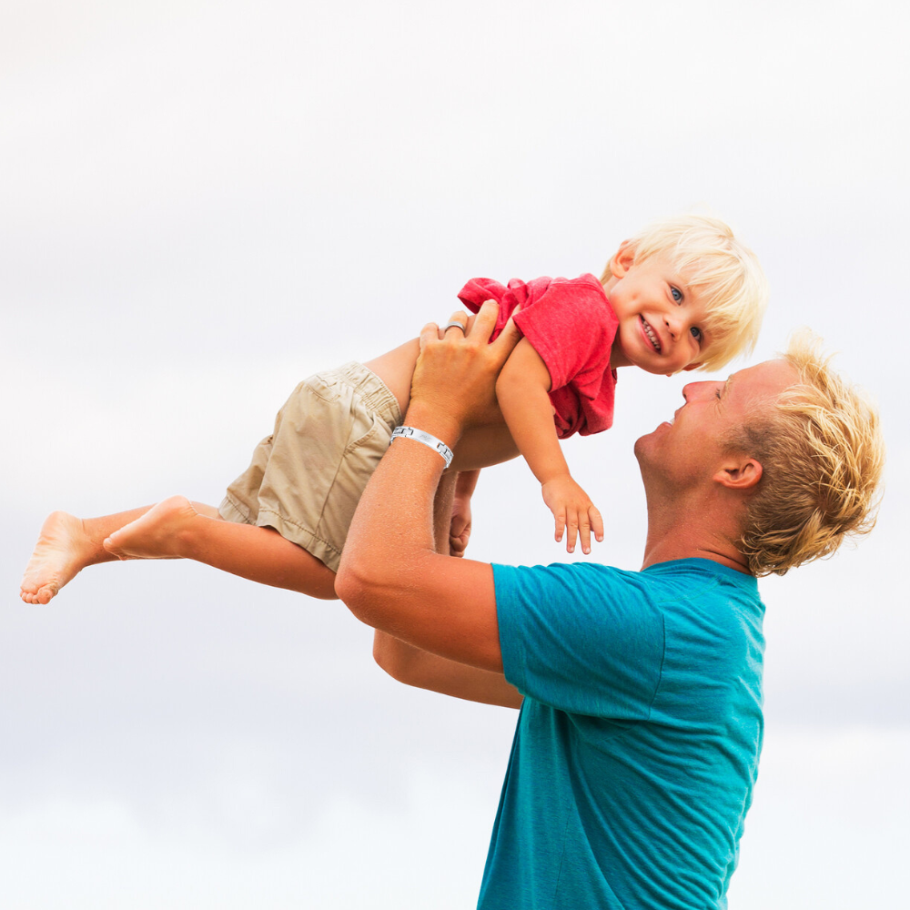 Dad holding son wearing Best dad ever etched silver bracelet